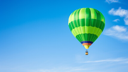 Fototapeta premium Colored hot air balloon on a clear blue sky with few clouds 