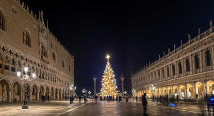Venice, Italy - December 19, 2023: Christmas tree with lights in San Marco square in the evening