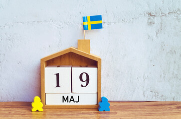 Wooden calendar with the date 19 May . Whit Sunday Sweden Holiday 