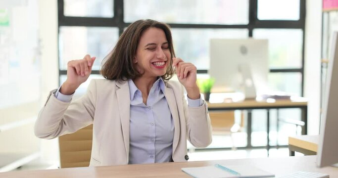 Happy businesswoman rejoicing and dancing at desk in office 4k movie slow motion