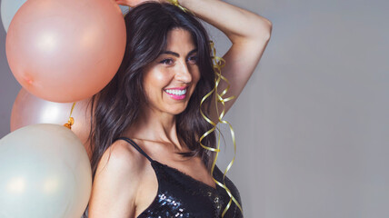 Beautiful smiling woman holding party balloons . Birthday concept