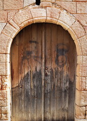 Old fashioned front door entrance, white facade and brown door, Rhodos, Greece