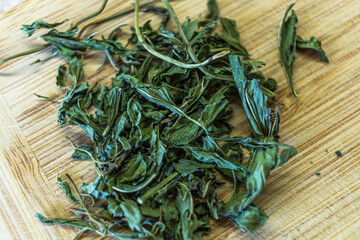 Dried Mentha spicata also known as spearmint lied down on a wooden, cutting board