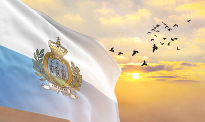 Waving flag of San Marino against the background of a sunset or sunrise. San Marino flag for Independence Day. The symbol of the state on wavy fabric. - obrazy, fototapety, plakaty