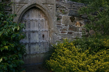 old wooden gate in stone wall