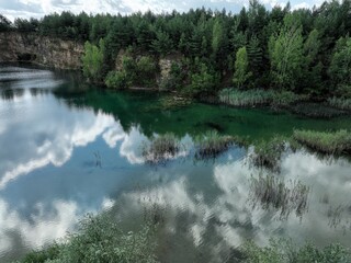 jezioro o przezroczystej wodzie pośród lasu oraz odbijające niebo, ekologiczny ekosystem, czyste powietrze, czysta woda,  świeże powietrze, las oraz woda  - obrazy, fototapety, plakaty