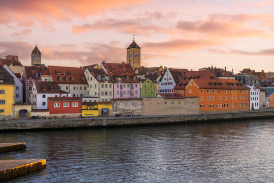 Cityscape of Regensburg at the river Daube during sunset
