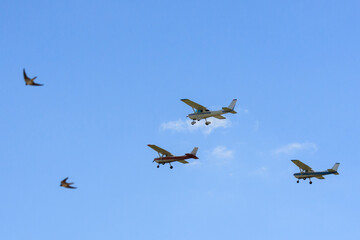 Small aircraft soaring through clear blue skies.