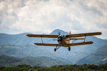 Fototapeta na wymiar Vintage biplane soaring against a vibrant sky, capturing the thrill of aviation's golden era.