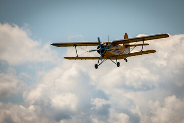 Vintage biplane soaring against a vibrant sky, capturing the thrill of aviation's golden era. © fluidni