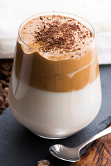 Dalgona coffee in glass cup. Korean trendy drink from instant coffee, milk and brown sugar