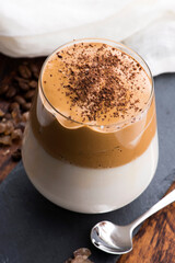 Dalgona coffee in glass cup. Korean trendy drink from instant coffee, milk and brown sugar