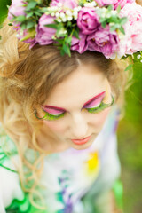 Woman with tulips, lily of the valley and pink peony in her hair