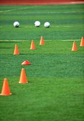 Group of football training cones on soccer field © xy