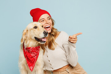 Young owner woman with her best friend retriever dog wear casual clothes red hat bandana point...