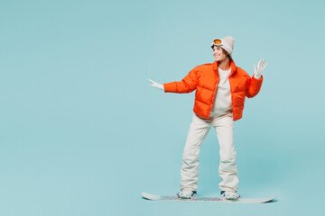 Full body confident young woman wear warm padded windbreaker jacket hat ski goggles mask...