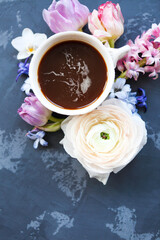Festive invitation card with beautiful flowers and cup of coffee