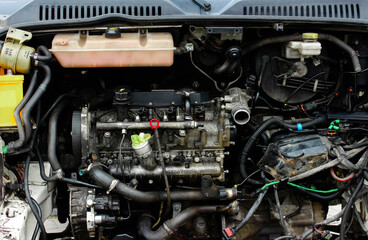 Fototapeta premium Open hood of a truck. Disassembled engine. Disassembled car. Car engine room under maintenance. Car service station. Car repair