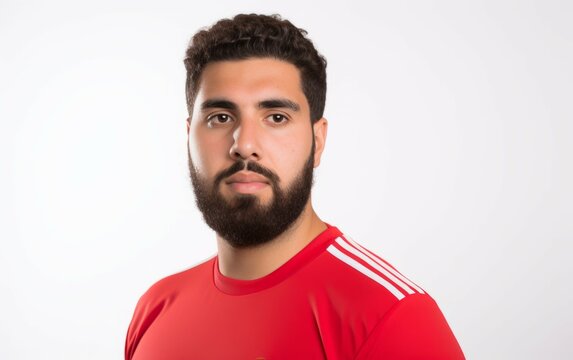 Portrait studio shot of a of male football soccer player wearing red jersey isolated on white background. closeup football player portrait against white background. copy space side. Generative AI