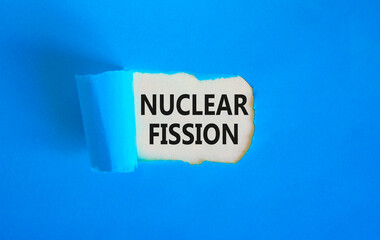 Nuclear fission symbol. Concept words Nuclear fission on beautiful white paper. Beautiful blue...