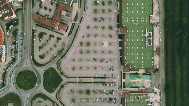 Aerial overhead shot of empty parking lots at the modern big shopping mall in Italy, economic crisis concept