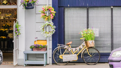 Vintage bicycle with front basket full of flowers