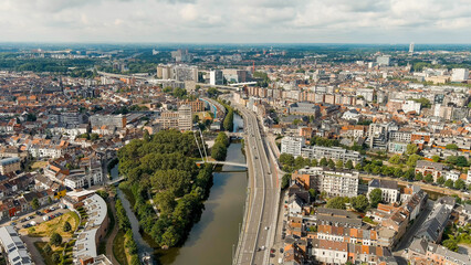 Fototapeta na wymiar Ghent, Belgium. Keizerpark - City park. Esco (Scheldt) river embankment. Panorama of the city from the air. Cloudy weather, summer day, Aerial View