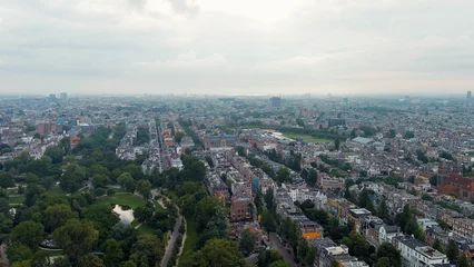 Fototapeten Amsterdam, Netherlands. Vondelpark. Museumplein square. Panoramic view of the city in summer in cloudy weather, Aerial View © nikitamaykov