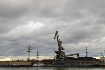 Fototapeta na wymiar cranes in port unloading coal