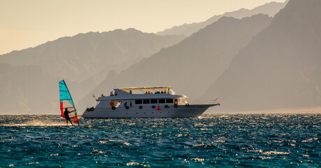 big boat and windsurfer on the background of high mountains in Egypt Dahab South Sinai