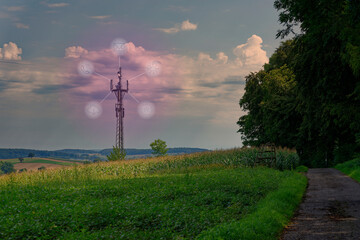 Mobile radio tower in the open nature, with fields, forests and meadows. Virtual icons regarding data connections and access to cloud data, phone, email, networking.