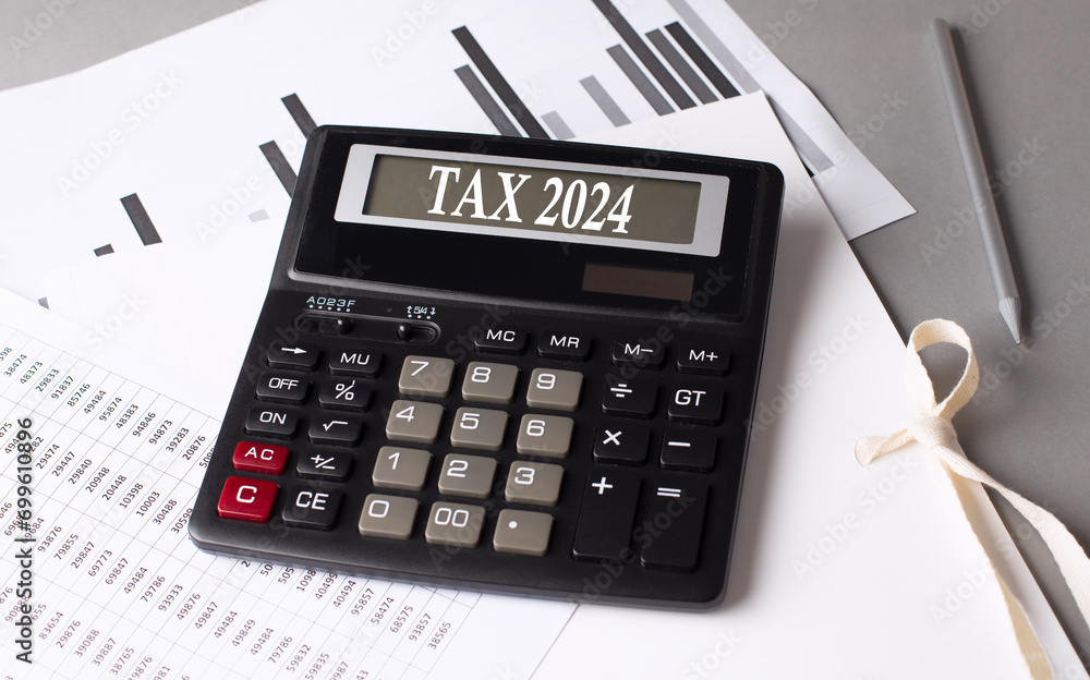 Poster tax 2024 text on calculator with chart on grey background