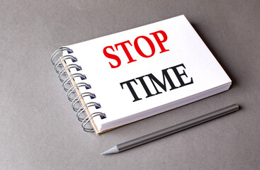 STOP TIME word on notebook on grey background