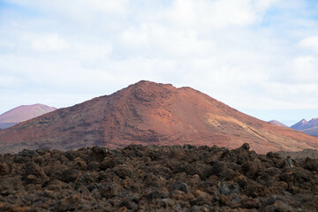 Spectacular view of the volcanic landscape in Timanfaya National Park. Lanzarote, Canary Islands, Spain, Atlantic, Europe. Tourism and vacations concept.