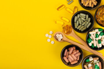 Vitamins and supplements. Variety of vitamin tablets on a textured background. Multivitamins with...