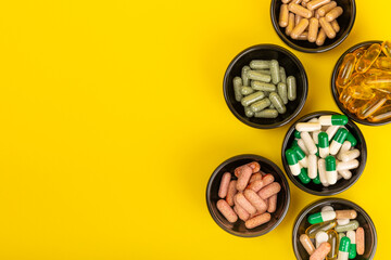Vitamins and supplements. Variety of vitamin tablets on a textured background. Multivitamins with fresh and healthy fruits. Nutritional supplements. Flat layout. Place for text. Copy space