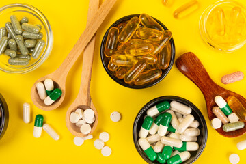 Vitamins and supplements. Variety of vitamin tablets in wooden spoons on a textured background. Multivitamin complex for every day. Nutritional supplements.Copy space.Vitamins for immunity