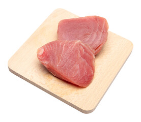 Fresh tuna Fish steak on a wooden cutting serving board isolated on a white background