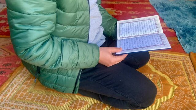 Reading Quran, Reading a Koran, Reading a Holy Quran with finger. Quranic reading. Reading in dark, Slowmotion Footage.
