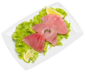 Fresh tuna Fish steak on a ceramic plate isolated