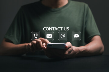 Customer support concept, businessman using smartphone with contact us icons.