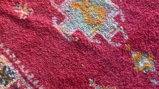 Detail of a handmade, traditional, Moroccan cactus silk (Sabra silk) rug, carpet. Macro closeup abstract geometric patterns, handwoven, shallow depth of field.
