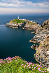 Fototapeta na wymiar South Stack lighthouse, on Anglesey, north Wales. The lighthouse is located on a small island just off the mainland and is reached by a flight of very steep stairs. It is a bright summers day