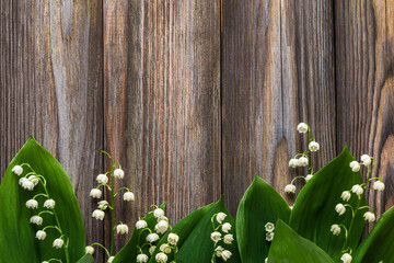 Lily of the valley flowers on rustic wooden background. Womens day, Valentines day card. Top view....