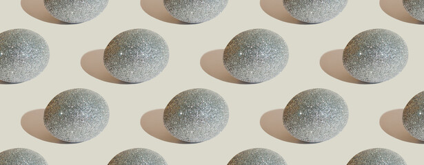 Easter pattern with glitter silver eggs on gray background. Easter background. Handmade decorated Easter eggs. Easter concept. Greeting card. Banner or header
