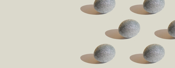 Glitter silver eggs on gray background. Minimal Easter background. Easter concept. Greeting card....
