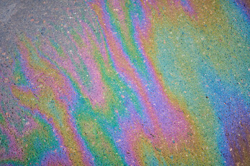 Gasoline pollution, oil, rainbow gasoline leak in the form of a glow on the sidewalk.