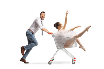 Man running and pushing a ballerina in a shopping cart