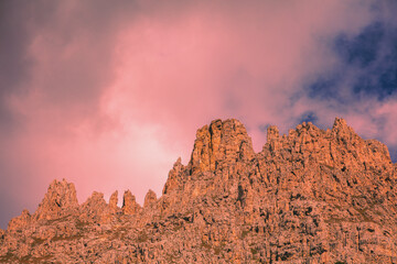 Mountain landscape in the evening. The Dolomites Alps against the sunset sky. Sella Pass, Grohmannspitze, Selva di Val Gardena, Bolzano, Italy