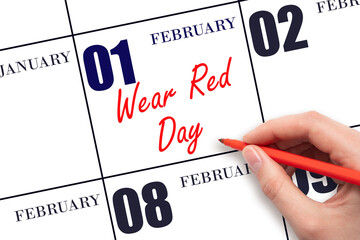 February 1. Hand writing text Wear Red Day on calendar date. Save the date.